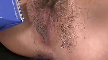 Asian gets her hairy pussy shaved